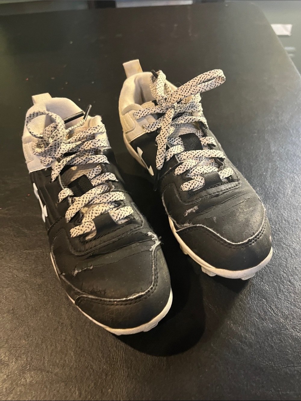 Black Under Armer Youth Size 13 Cleats.